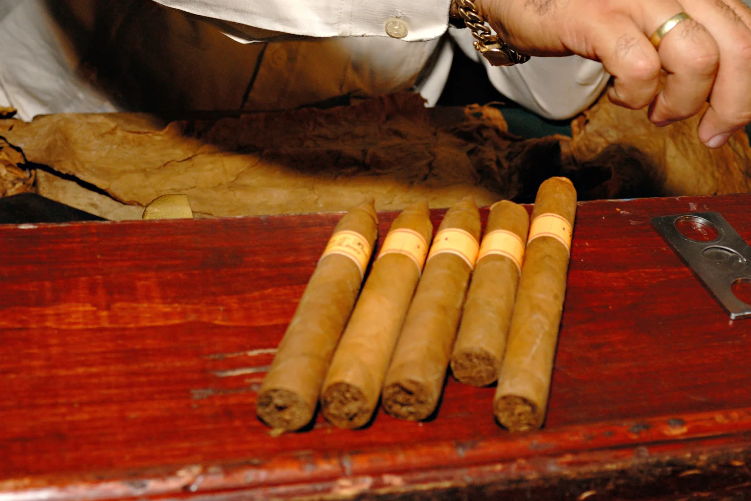 Selection of differently shaped cigars on a cigar roller’s workbench