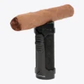 Lotus Armor Triple Torch Lighter holding a cigar on its rest cap