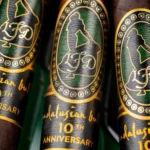 Close up of the green, black and gold Andalusian Bull 10th Anniversary bands on maduro wrappers