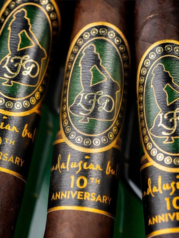 Close up of the green, black and gold Andalusian Bull 10th Anniversary bands on maduro wrappers