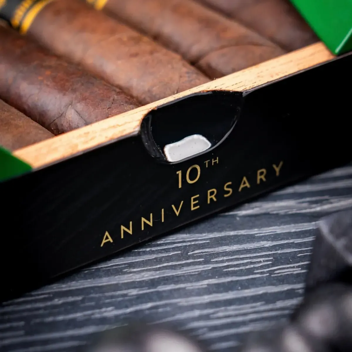 Box front stamped 10th Anniversary with maduro cigars inside