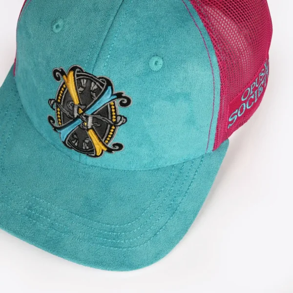 Opus X Society Trucker Hat Miami Vice Suede Teal and Magenta Limited Edition 5 Opus X Society Miami Vice trucker hat, angled front view of the crest patch on teal suede