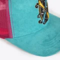 Close up of the Opus X Society crest patch on the teal suede front