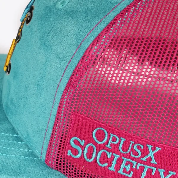 Opus X Society Trucker Hat Miami Vice Suede Teal and Magenta Limited Edition 7 Close up of the magenta Opus X Society side patch with teal lettering