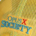 Close up of the Opus X Society embroidery with a red X on the yellow mesh back